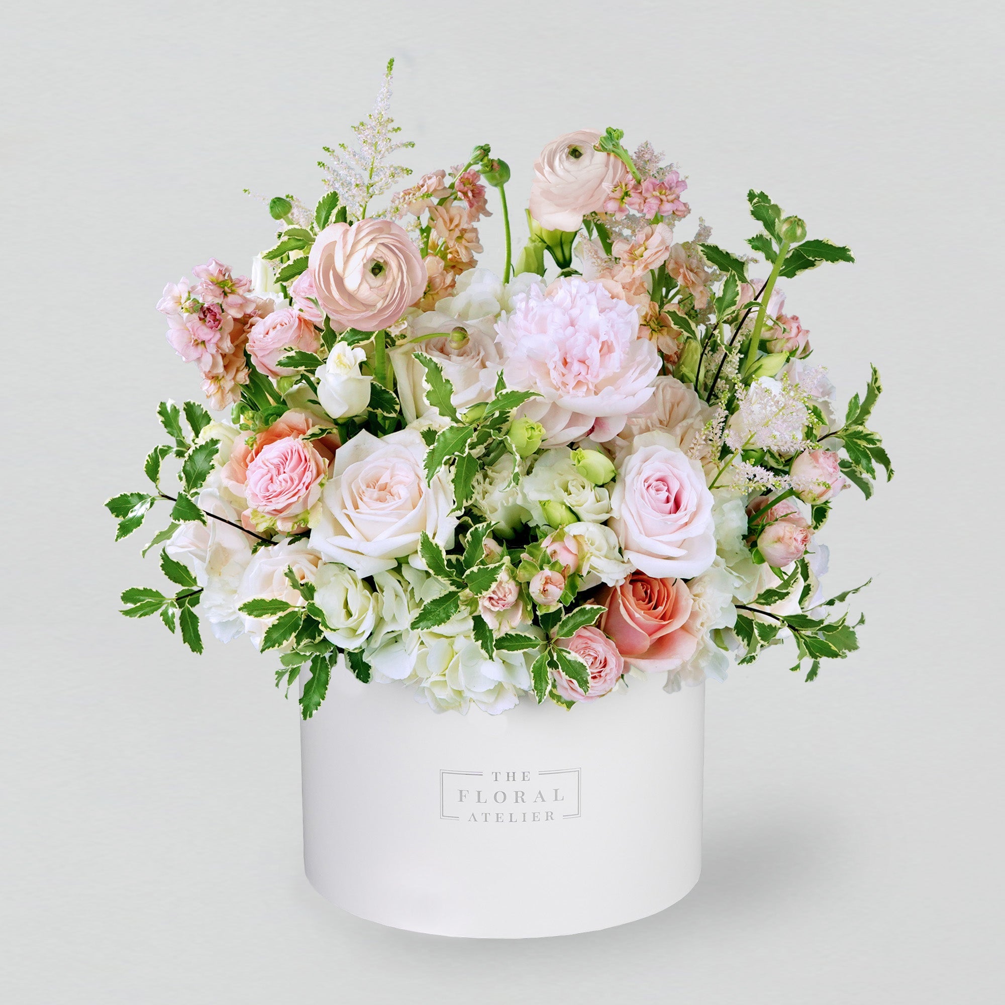 Pink fresh flowers in a white round box