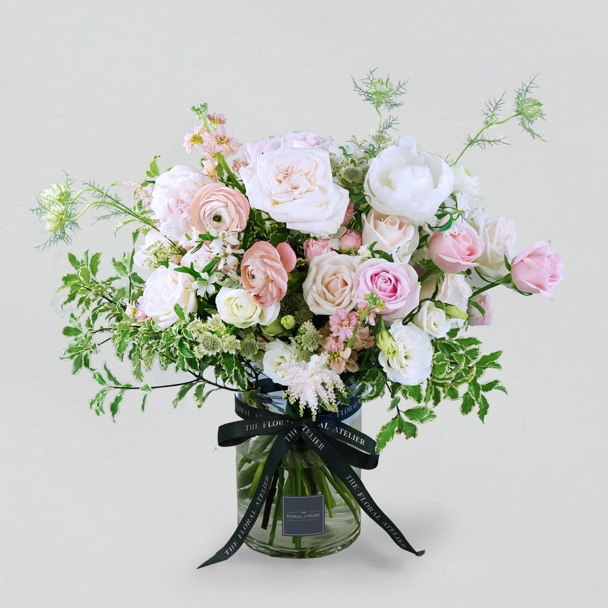 Pastel fresh florals in pink and white, arranged in a bouquet