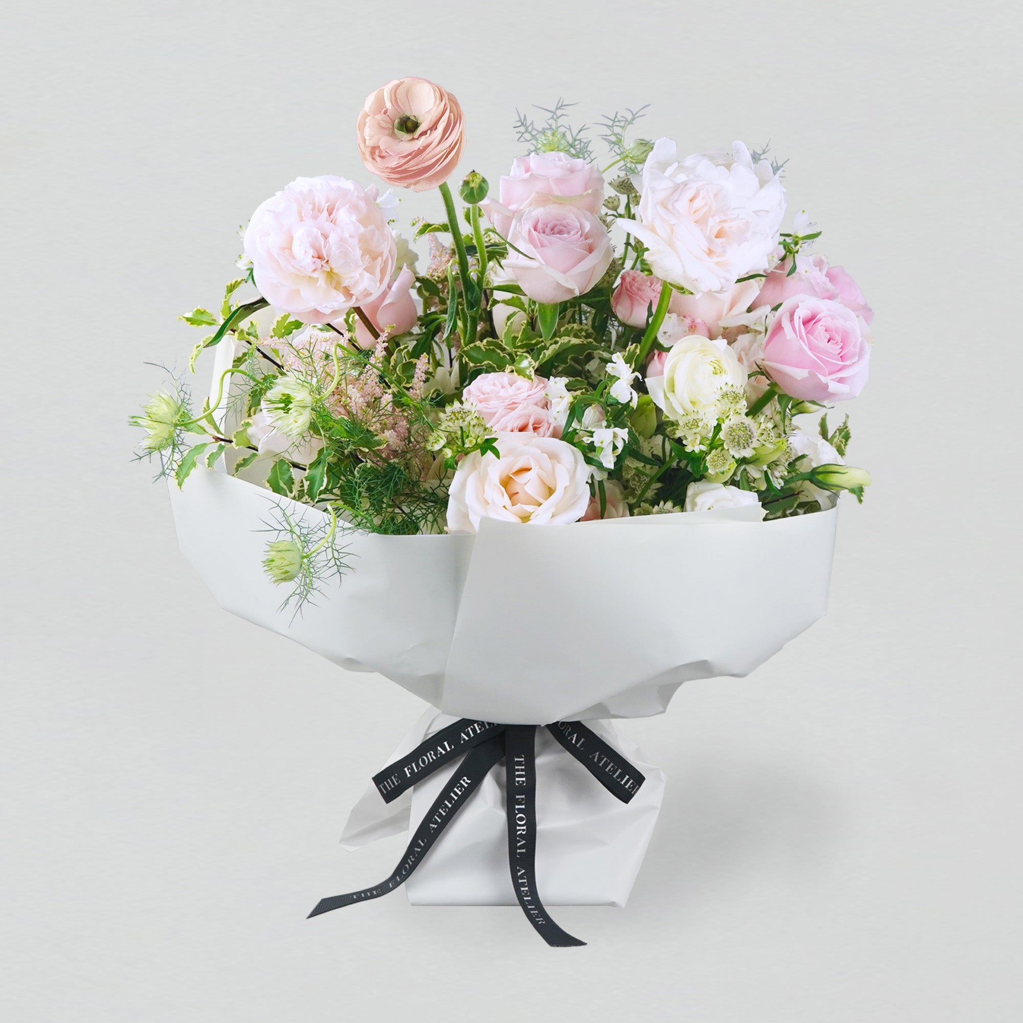 Pastel fresh florals in pink and white, arranged in a bouquet
