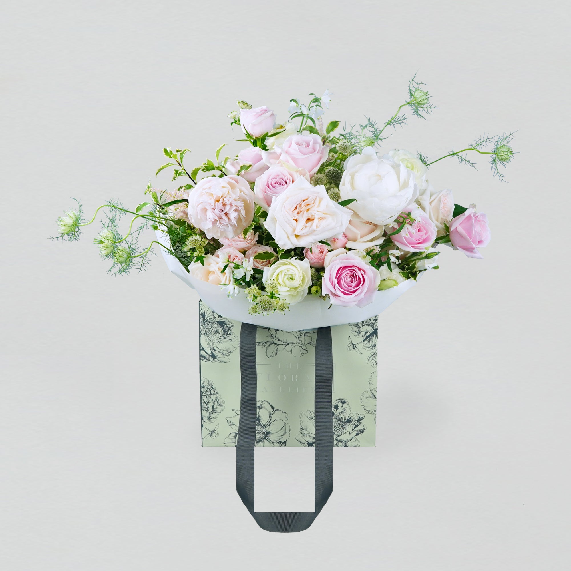 Pastel fresh florals in pink and white, arranged in a bouquet