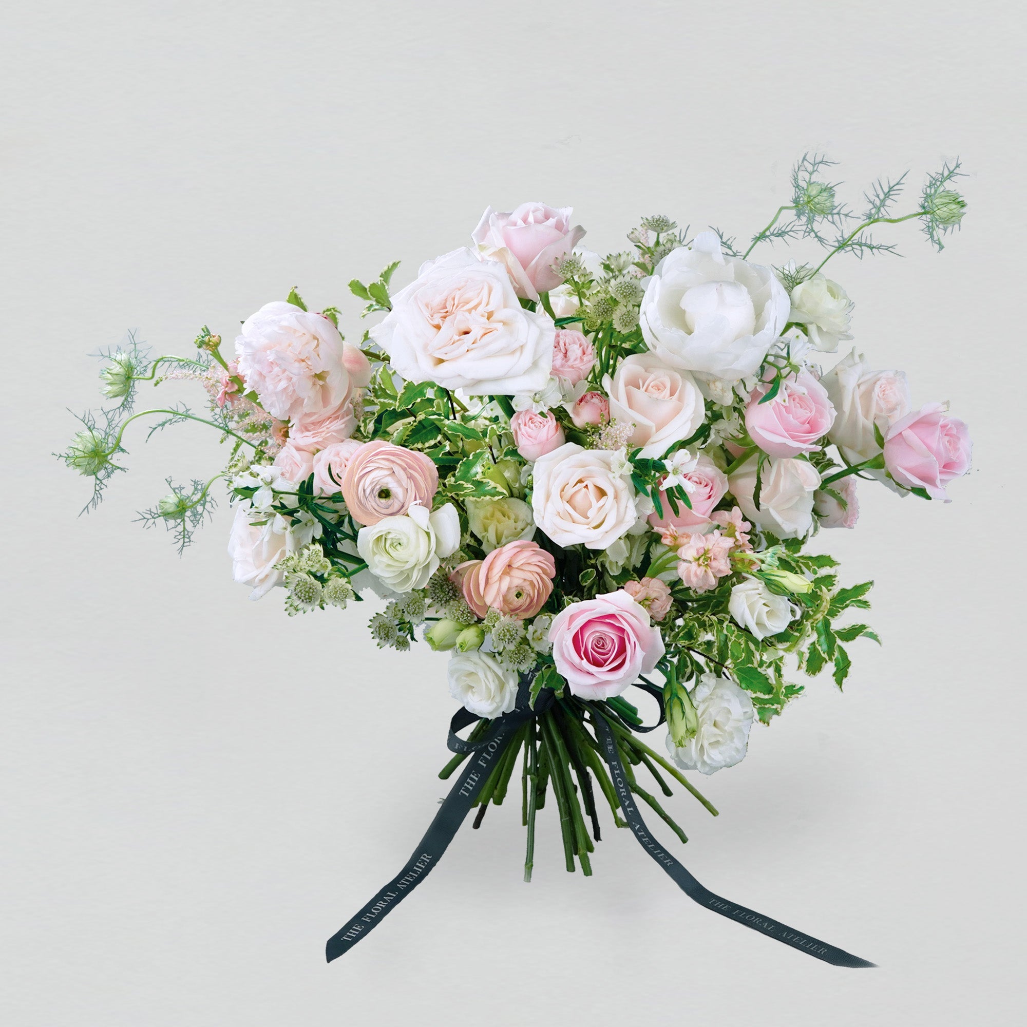 Pastel fresh florals in pink and white, arranged in a bouquet