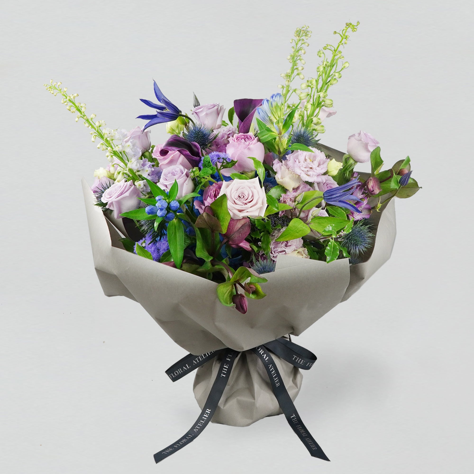 Fresh violet, lilac and blue florals arranged in a bouquet