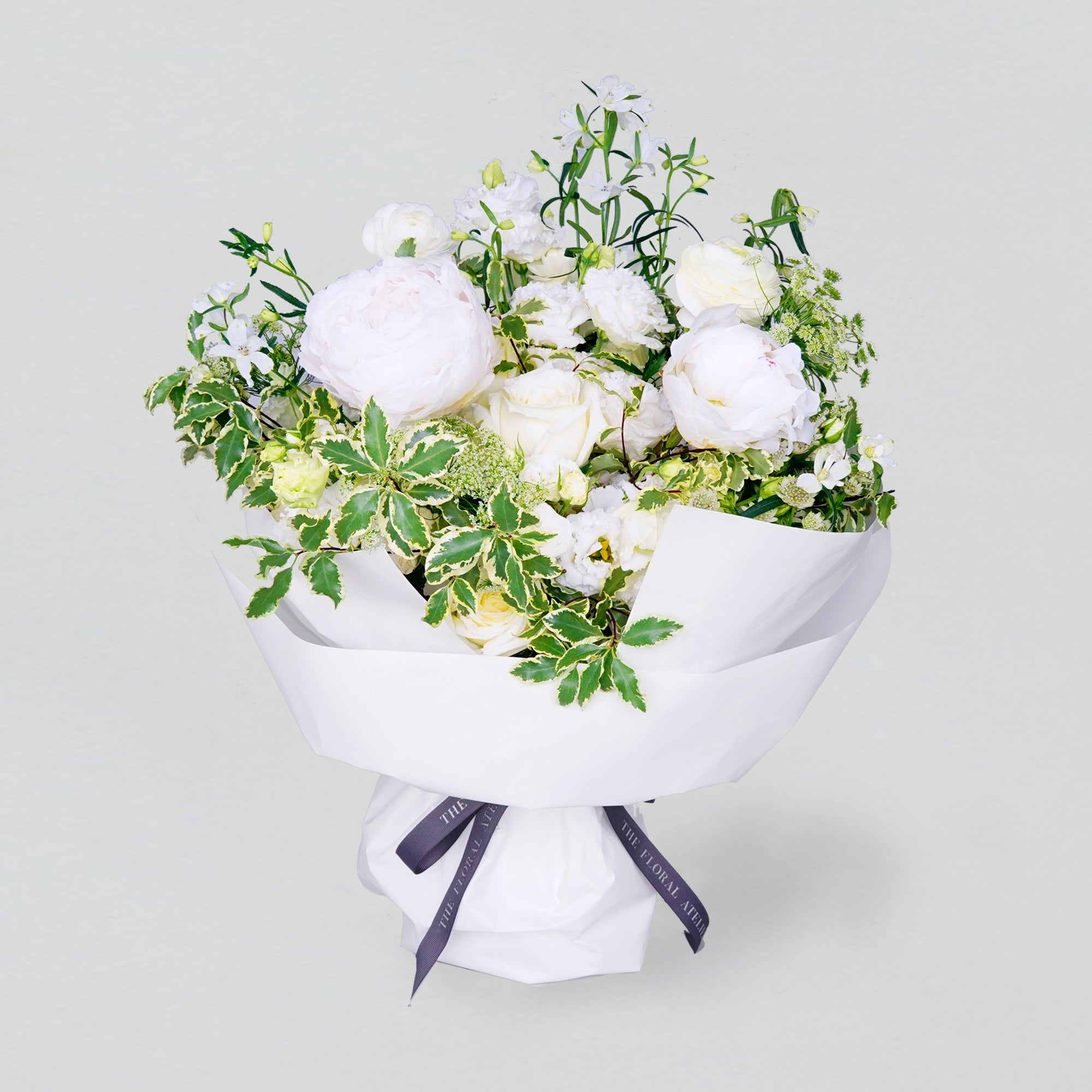 Fresh white and green florals arranged in a bouquet