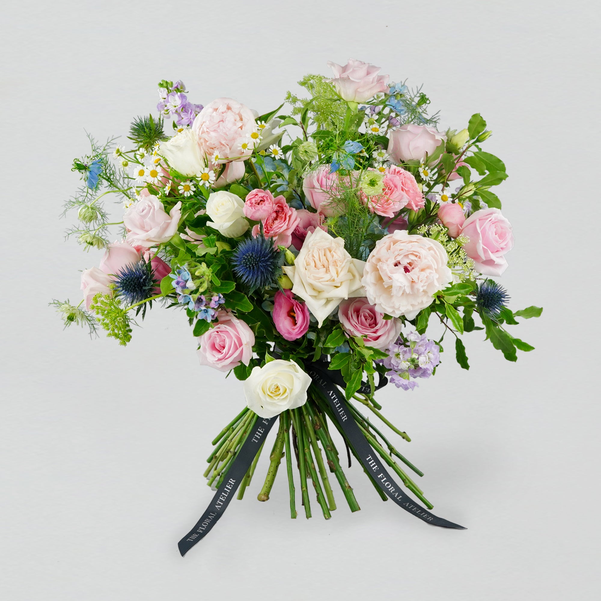Pastel fresh florals in blue, pink and lilac, arranged in a bouquet