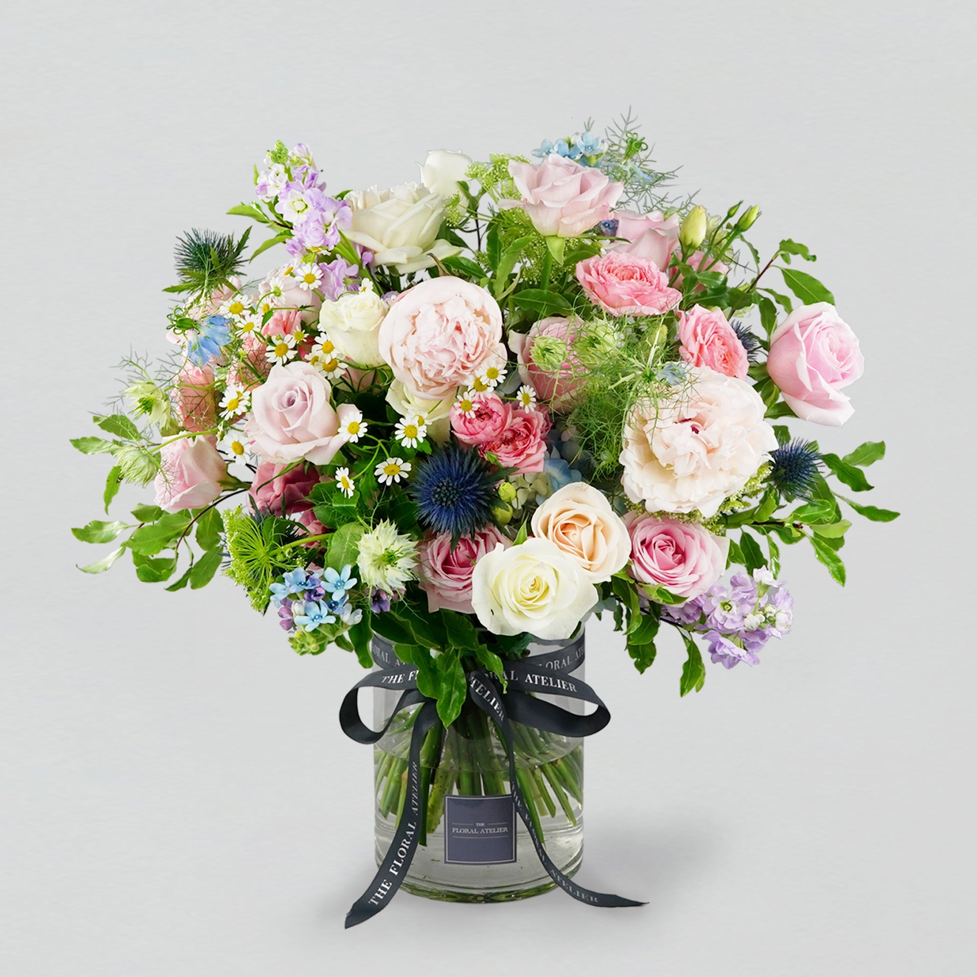 Pastel fresh florals in blue, pink and lilac, arranged in a bouquet