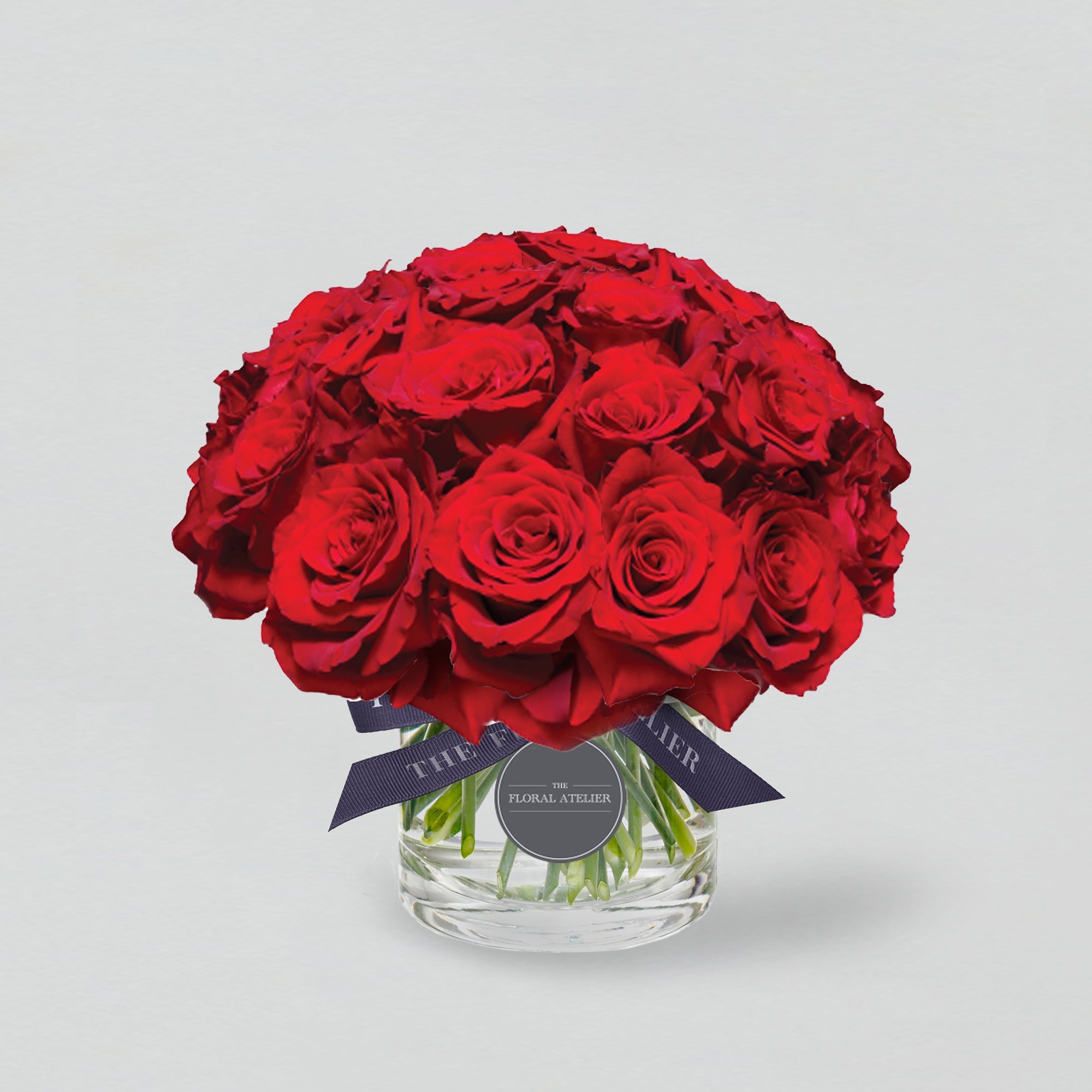 Fresh red roses arranged in a clear glass vase